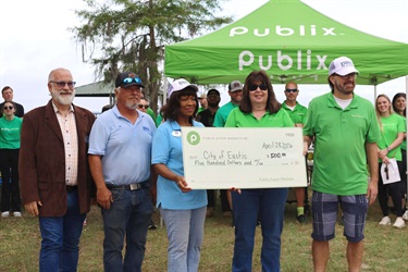 Publix presenting the City of Eustis with a check for future Eustis in Bloom projects.
