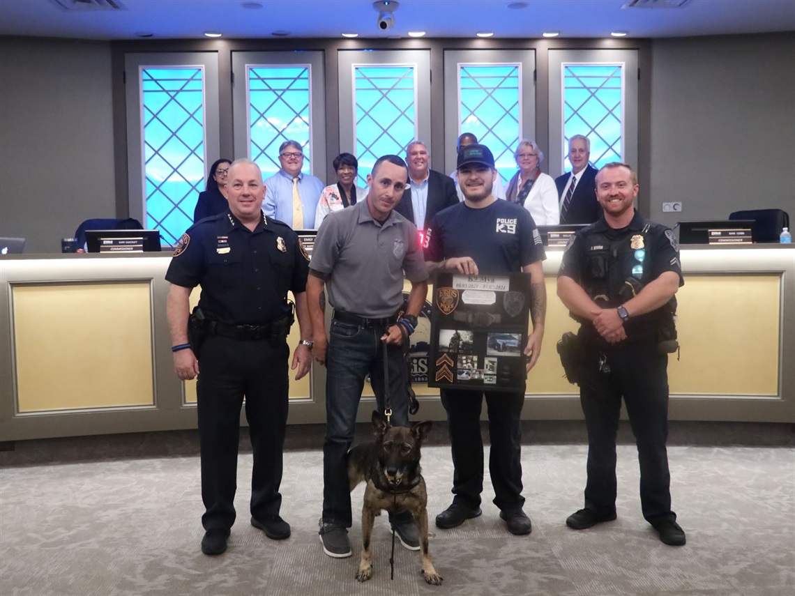 K9 Officer Mya with Chief Capri, Officer Cortes and Cauy Kerley. City Commission.